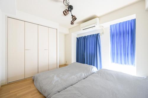Säng eller sängar i ett rum på PREMIER suite Shinjuku takadanobaba