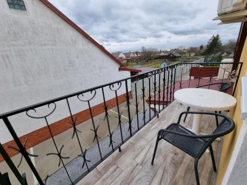 a balcony with a table and chairs on it at Heléna Hotel & SPA in Levél