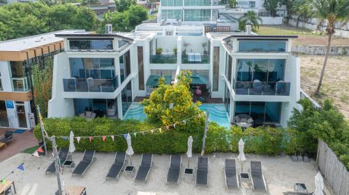 an aerial view of a house with a swimming pool at 【Beach Front】海景沙滩别墅，私人泳池，免费早餐，女佣每日清洁，生活方便交通便利 in Phuket Town