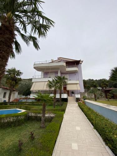 a villa with a swimming pool and a building at Sunny villa Borakaj Vlora in Vlorë