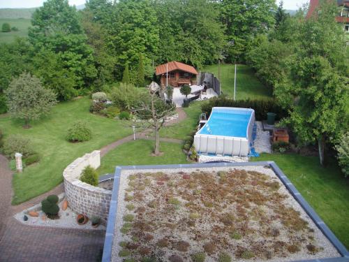 an aerial view of a backyard with a swimming pool at Außergewöhnliche Ferienwohnung in modernen Styl in Weiding
