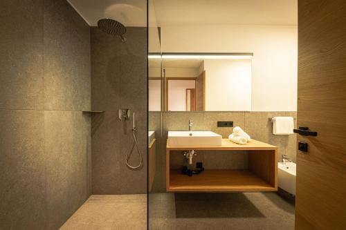 a bathroom with a sink and a mirror at MANARES - my mountain stay in San Lorenzo di Sebato