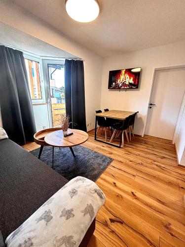 a living room with a couch and a table with a fire in it at RM-Apartments in Innsbruck