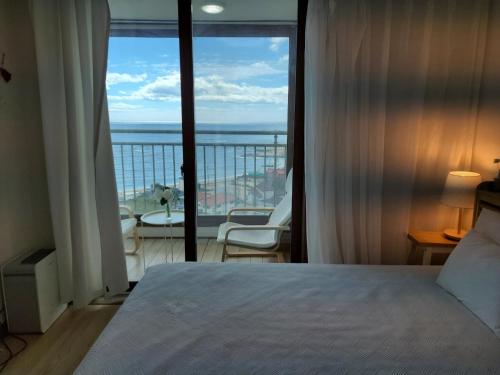 a bedroom with a bed and a view of the ocean at Goseong Ayajin Perfect oceanview holiday sunset house in Goseong