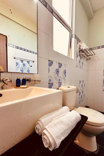 a bathroom with a tub and a toilet and a sink at Luna Waves in Negombo