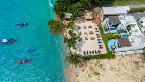 an aerial view of an island with boats in the water at 【Beach Front】海景沙滩别墅，私人泳池，免费早餐，女佣每日清洁，生活方便交通便利 B in Phuket Town