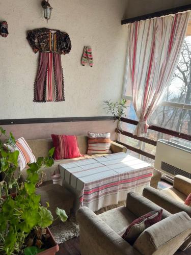 a living room with a couch and a bed at Комплекс Тополица -The beautiful view in Aytos