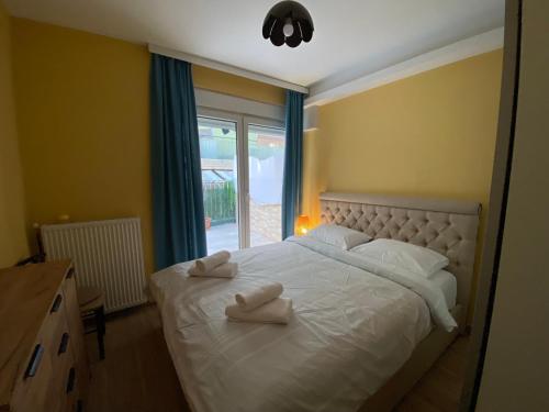 1 dormitorio con 1 cama y 2 toallas blancas en Danka Apartment, en Tesalónica