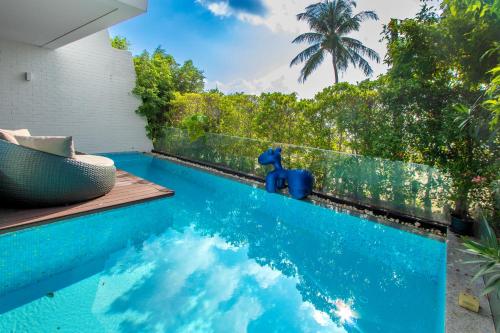 a pool with a blue elephant toy next to a fence at 【Beach Front】海景沙滩别墅，私人泳池，免费早餐，女佣每日清洁，生活方便交通便利 B in Phuket Town