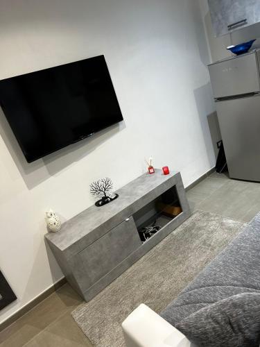 a living room with a flat screen tv on a wall at Roby & Simo in San Giorgio a Cremano