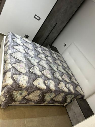 a large bed in a room with a blanket at Roby & Simo in San Giorgio a Cremano
