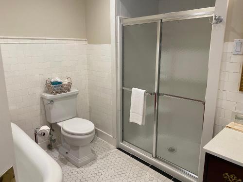 a bathroom with a shower and a toilet and a sink at Copper Beech Inn in Ivoryton