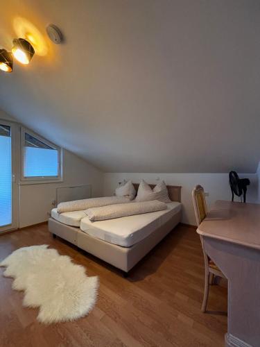 a bedroom with two beds and a white rug at RM-Apartments in Innsbruck