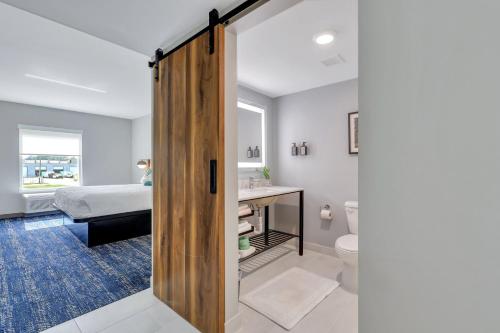 a bathroom with a door leading to a bedroom at The Kingston in Savannah