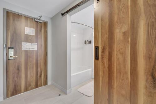 a bathroom with a shower and a wooden door at The Kingston in Savannah