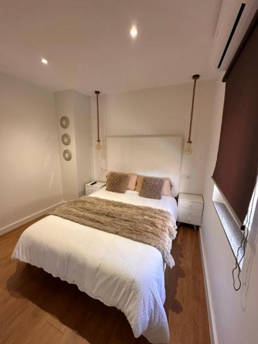 a bedroom with two beds and a flat screen tv at Candelaria in Astorga