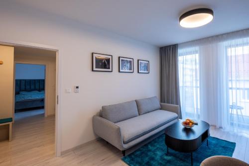 a living room with a couch and a table at Apartment EDIAS ONE in Banská Bystrica