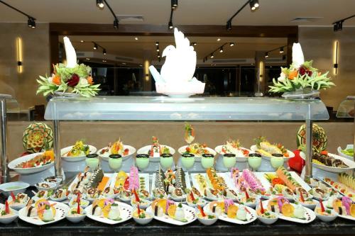 a buffet of sushi and other food on display at Blend Elphistone Resort Marsa Alam in Abu Dabab