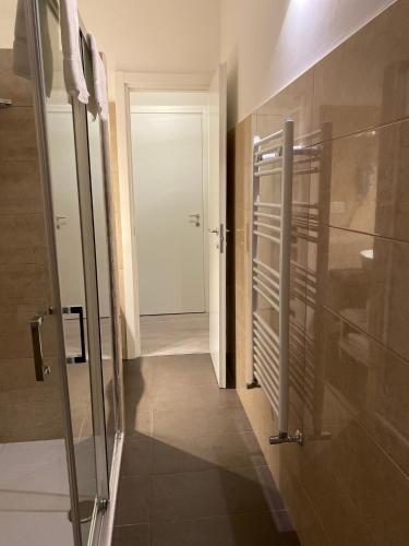a bathroom with a glass door and a hallway at Midtown Salerno in Salerno