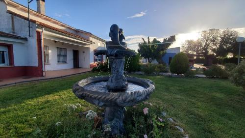 a stone fountain in the yard of a house at Complejo en el medio del campo! 