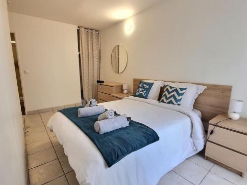 a bedroom with a large bed with towels on it at Le Cosy Wiener *Paris*Gare à 300 m*Disneyland* in Champs-Sur-Marne