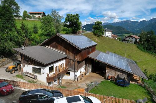 an aerial view of a house with solar panels on it at Thalerhof in Feldthurns
