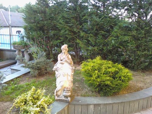 a statue of a woman sitting in a garden at Da Betty in Asti