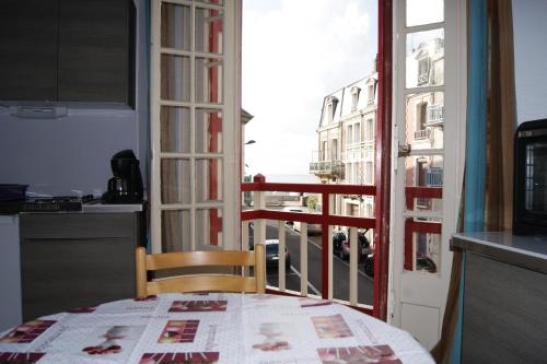 a kitchen with a table and a view of a city at La Précieuse in Mers-les-Bains