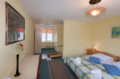 a hotel room with two beds and a staircase at Info Hotel Apartments in Palanga