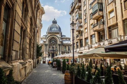 a city street with buildings and a building with a dome at Old town apartment in Bucharest