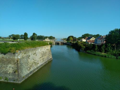 an aerial view of a river with a bridge at Logis Varennes in Gravelines