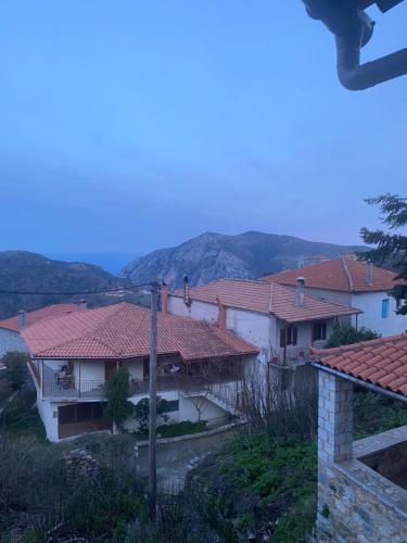 a group of houses with mountains in the background at Apostolia's Small House Bed and view in Anavrití