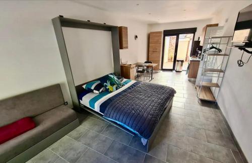 1 dormitorio con 1 cama y 1 sofá en L Auberge du mont des bruyeres PLAIN PIED, en Saint-Amand-les-Eaux