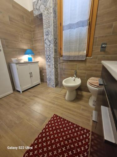 a bathroom with a toilet and a bidet and a sink at Casa Sabrina in San Vito lo Capo