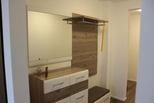 a bathroom with a large mirror on the wall at Meereszeit - OlpenitzResort in Olpenitz