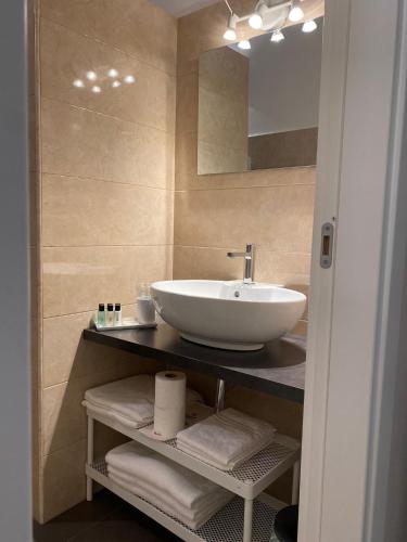 a bathroom with a sink and a mirror at Midtown Salerno in Salerno