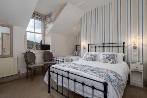 a bedroom with two beds and a window at 2 Cambridge Villas B & B in Ambleside