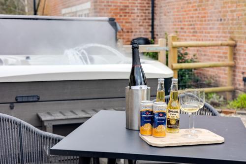 a table with bottles of wine and glasses on it at Oak Tree Hideaway in Whitchurch