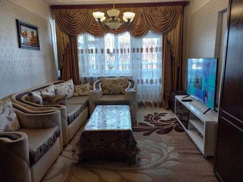 a living room with a couch and a tv at Nina BNB in Sevan