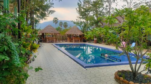 a swimming pool at a resort with a resort at Jasmine Resort Kampot in Kampot
