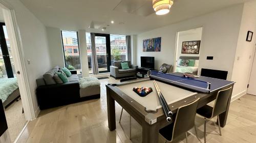 a living room with a pool table in it at Lux Livin' Apartments - Luxury 2 Bed Apartment with Sky Garden in Manchester