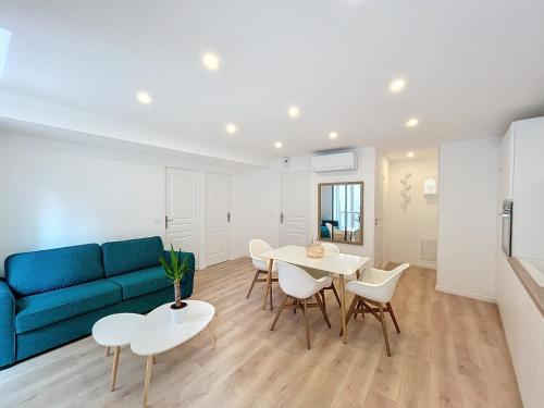 un salon avec un canapé bleu, une table et des chaises dans l'établissement Zoé T3 Victor Hugo Clim Hypercentre, à Grenoble