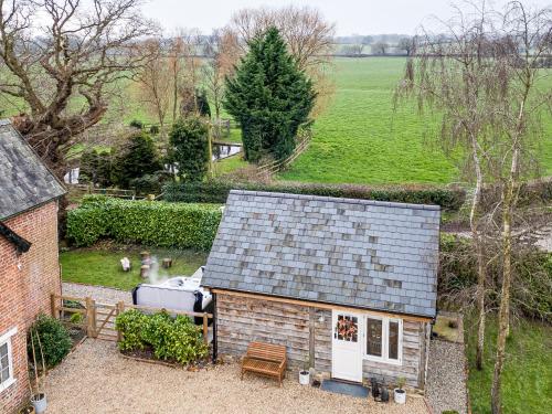 an aerial view of a house with a roof at Oak Tree Hideaway in Whitchurch