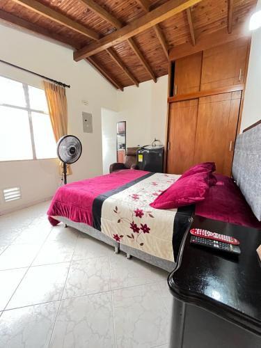 a bedroom with a large bed and a desk at aparta estudio en envigado in Envigado