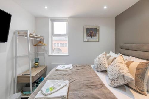 a bedroom with a large bed and a window at Modern Studio Retreat Near Shop's! in Ealing