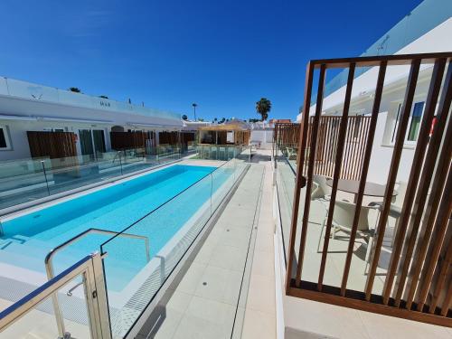 a swimming pool on the side of a building at MAR BIANCO - Gay Men Only in Maspalomas