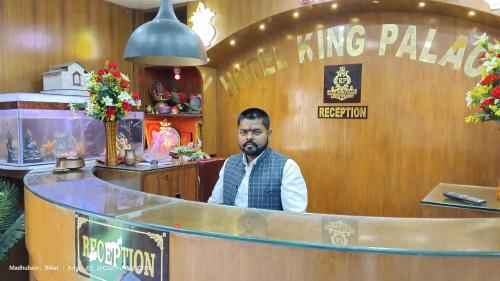 a man sitting at a bar in a restaurant at Hotel king palace madhubani in Madhubani