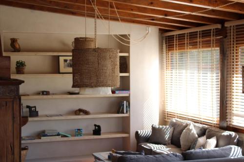 a living room with a couch and some shelves at Hotel Calitxo in Molló
