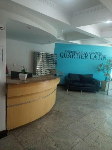 a lobby with a counter and a couch at Apart Quartier Latin in Vitória