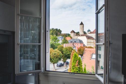 an open window with a view of a city at Auberge d'Ajoie in Porrentruy